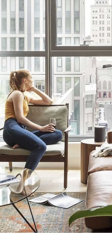 Roost guest relaxing in modern apartment-style suite – extended stay hotel featured in hospitality marketing campaign by Gourmet Marketing