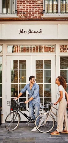 The Pinch Charleston entrance with couple and bikes – boutique hotel featured in digital marketing campaign by Gourmet Marketing